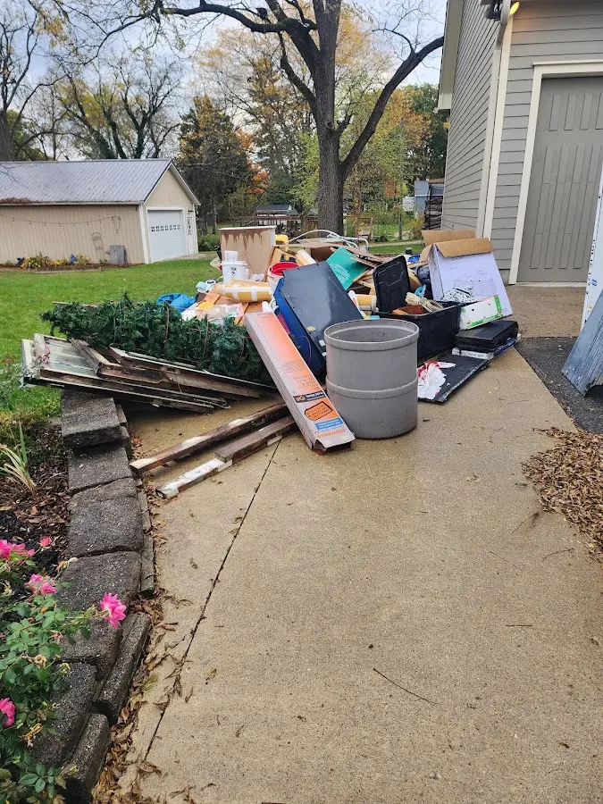 Dumpster being loaded with debris for Commercial Dumpster Rental in Garland